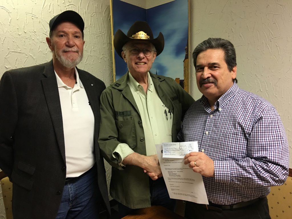 Keith Archer, Tom Greco presenting $3,500 check to Leonardo Zapata, new Business Administrator at Holy Spirit Catholic Church.